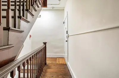 a stairway with a white wall and wooden floors at Dreamy 2BR in Downtown Princeton in Princeton