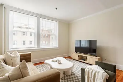 a living room with a couch and a tv at Dreamy 2BR in Downtown Princeton in Princeton
