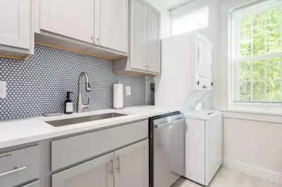 a white kitchen with a sink and a dishwasher at Fun & Funky 2BR in Downtown Princeton in Princeton