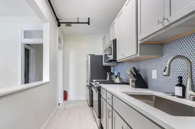 a kitchen with white cabinets and a sink at Fun & Funky 2BR in Downtown Princeton in Princeton