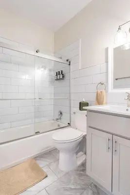 a white bathroom with a toilet and a sink at Fun & Funky 2BR in Downtown Princeton in Princeton