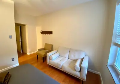 a living room with a couch and a chair at Historic Townhouse Oasis with En-suite Bathroom in Philadelphia