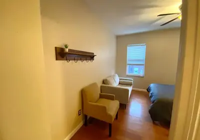 a living room with a couch and a chair at Historic Townhouse Oasis with En-suite Bathroom in Philadelphia