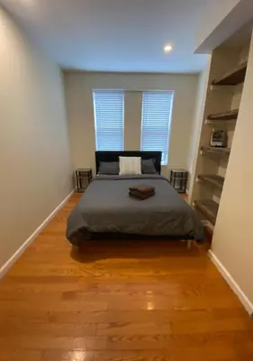 a bedroom with a bed and a large window at Historic Townhouse Oasis with En-suite Bathroom in Philadelphia