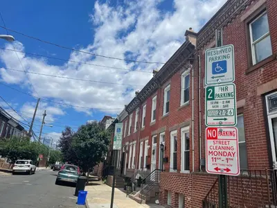 a street sign in front of a brick building at Historic Townhouse Oasis with En-suite Bathroom in Philadelphia