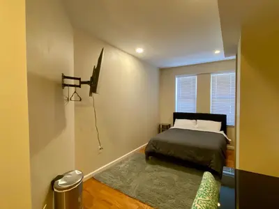 a small bedroom with a bed and a window at Historic Townhouse Oasis with En-suite Bathroom in Philadelphia