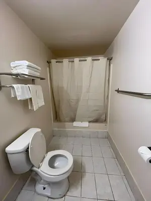 a bathroom with a toilet and a shower at Scottish Inns - Middletown in Middletown