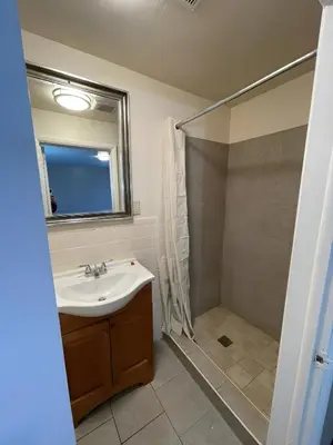 a bathroom with a sink and a shower at Scottish Inns - Middletown in Middletown