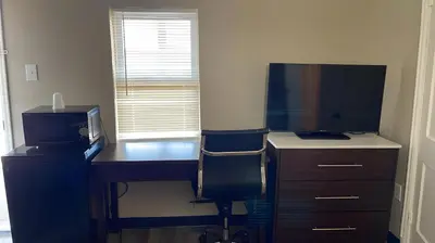 an office with a desk with a computer and a monitor at Scottish Inns - Middletown in Middletown