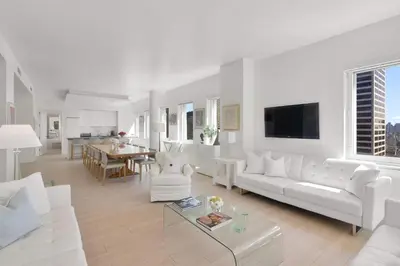 a white living room with a white couch and a table at Exclusive Apartment Midtown Manhattan NYC Luxury Penthouse Sleeps 8 in New York