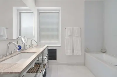 a white bathroom with two sinks and a bath tub at Exclusive Apartment Midtown Manhattan NYC Luxury Penthouse Sleeps 8 in New York