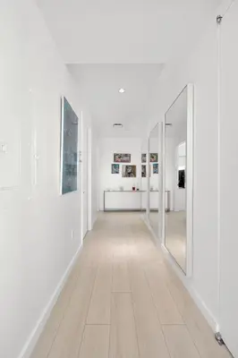 an empty hallway with white walls and mirrors at Exclusive Apartment Midtown Manhattan NYC Luxury Penthouse Sleeps 8 in New York