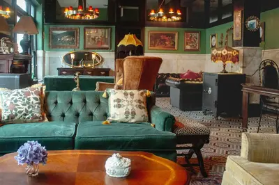 a living room with a green couch and a table at The Nolita Express Hostel in New York