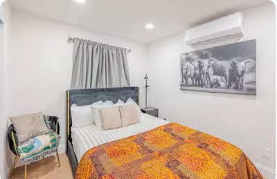 a bedroom with a bed and a chair at Exquisite 3 Bedrooms in Newark