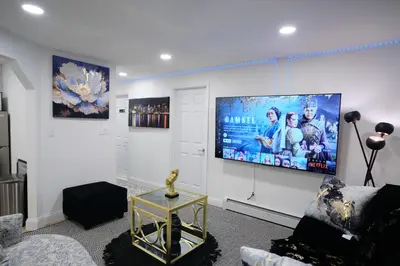 a living room with a flat screen tv on the wall at Exquisite 3 Bedrooms in Newark