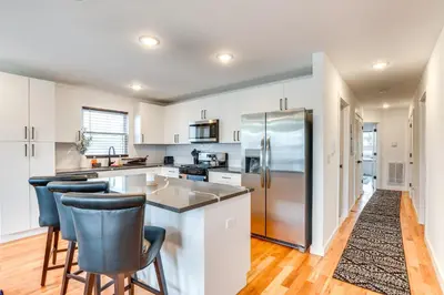 a kitchen with white cabinets and bar stools at Modern Elizabeth Apartment about 1 Mi to Train Station in Elizabeth