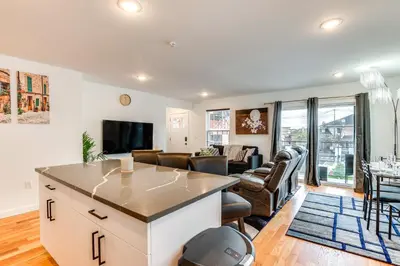 a living room with a kitchen and a living room with a couch at Modern Elizabeth Apartment about 1 Mi to Train Station in Elizabeth