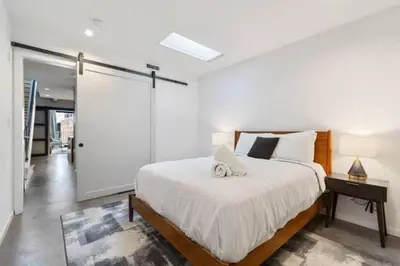 a bedroom with a bed and a sliding glass door at Inventors' Loft - Stay in the Heart of it All in Philadelphia