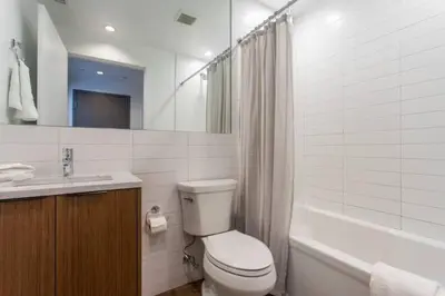 a bathroom with a toilet and a sink and a tub at Inventors' Loft - Stay in the Heart of it All in Philadelphia