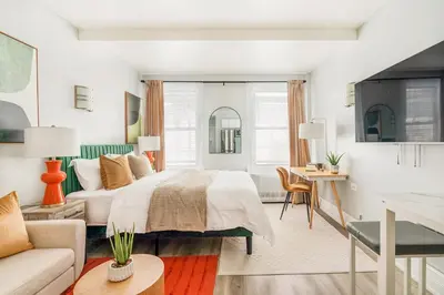 a bedroom with a bed and a living room at 73-819 New Studio UWS Doorman Gym in New York