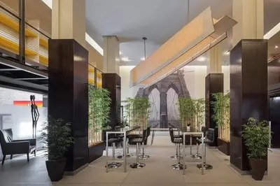 a lobby with tables and chairs and a building at 73-819 New Studio UWS Doorman Gym in New York