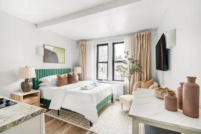 a white room with a bed and a kitchen at 73-919 New Studio UWS Doorman Gym in New York