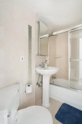 a bathroom with a sink and a toilet and a tub at 73-919 New Studio UWS Doorman Gym in New York