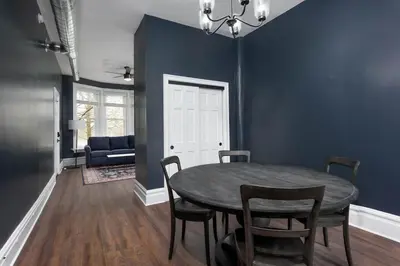 a dining room with blue walls and a table and chairs at Flats on Front - Riverfront Gem Fast Wi-Fi 2F in Harrisburg