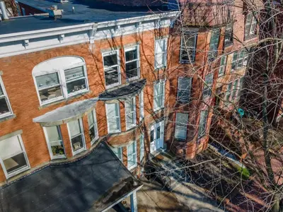 an overhead view of a brick building with a roof at Flats on Front - Riverfront Gem Fast Wi-Fi 1F in Harrisburg