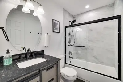 a bathroom with a shower and a sink and a toilet at 30 Day Minimum Stay - Private Creekside Solace in East Stroudsburg
