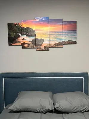 a painting of the sunset over the ocean at 4 Bedroom Apartment in Hillside