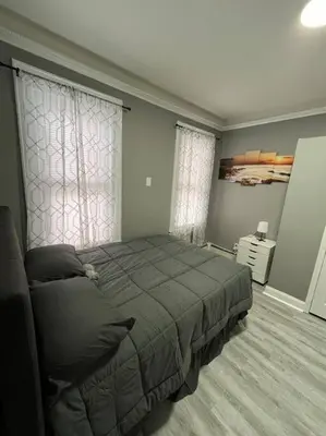 a bedroom with a large bed in a room at 4 Bedroom Apartment in Hillside