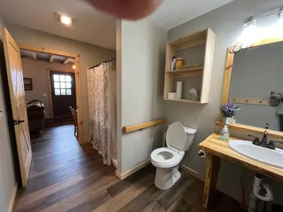 a bathroom with a toilet and a sink at The Lodge by Towanda and Sayre PA in Ulster