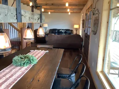 a living room with a wooden table and a couch at The Lodge by Towanda and Sayre PA in Ulster