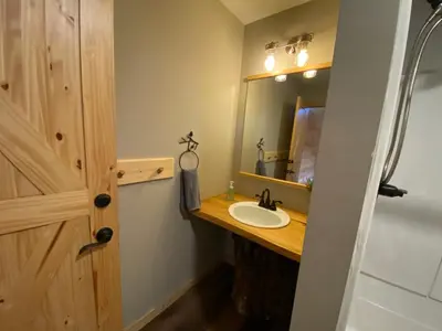 a bathroom with a sink and a mirror at The Lodge by Towanda and Sayre PA in Ulster