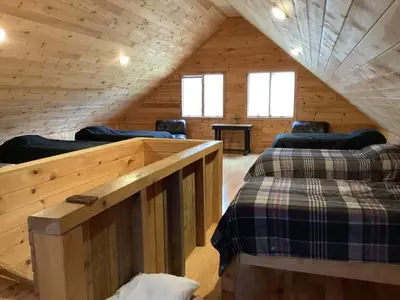 a room with four beds in a wooden cabin at Mighty Oak near Sayre Towanda in Ulster