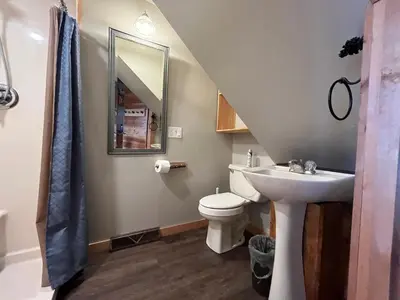 a bathroom with a sink toilet and a mirror at Mighty Oak near Sayre Towanda in Ulster