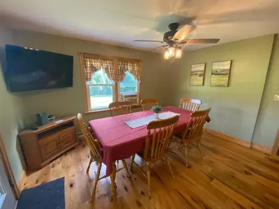 a dining room with a red table and chairs at StoneBrook Haven near Guthrie RPH Towanda Campus in Ulster
