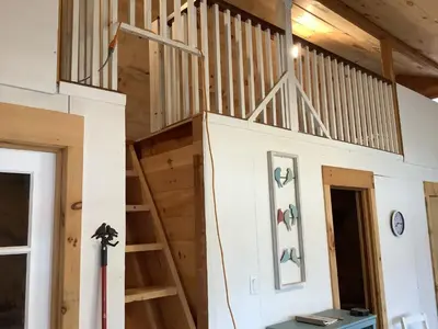 a loft bed in a tiny house at Willow Point Cabin Brenchly Lake in Ulster