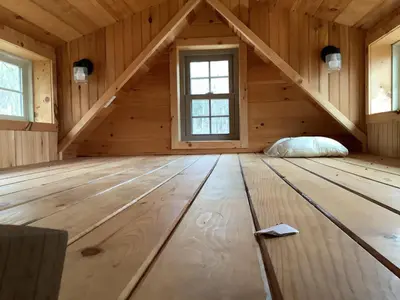 a room in a log cabin with a window at Lakeside Tiny Cozy Retreat in Ulster