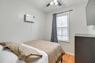 a bedroom with a bed and a window at Jersey City Apartment with Game Room 7 Mi to NYC! in Jersey City