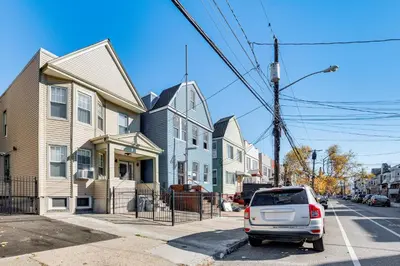 a white car parked in front of a house at Jersey City Apartment with Game Room 7 Mi to NYC! in Jersey City