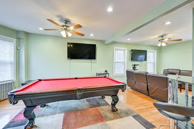a room with a pool table and a flat screen tv at Jersey City Apartment with Game Room 7 Mi to NYC! in Jersey City