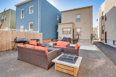a patio with two wicker chairs and a table at Jersey City Apartment with Game Room 7 Mi to NYC! in Jersey City