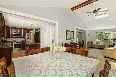 a dining room and living room with a table and a kitchen at Large Private House on 5 Wooded Acres. Total Privacy! in Hackettstown