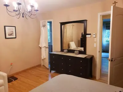 a bathroom with a black dresser and a mirror at Large Private House on 5 Wooded Acres. Total Privacy! in Hackettstown