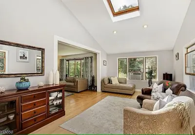 a living room with a couch and a table at Large Private House on 5 Wooded Acres. Total Privacy! in Hackettstown