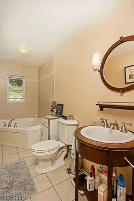 a bathroom with a toilet and a sink and a tub at Large Private House on 5 Wooded Acres. Total Privacy! in Hackettstown