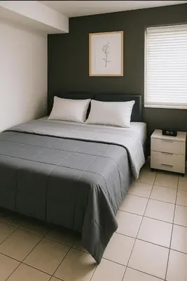 a bedroom with a large bed with white pillows at Serenity Cove -2 Bedroom Apartment in Newark