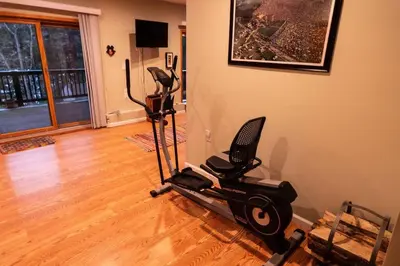 a room with a gym with a exercise bike at Whimsical Lakefront Chalet in Monticello